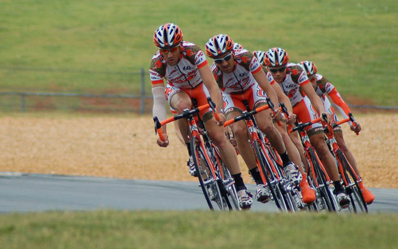 an orange cyclist team on road